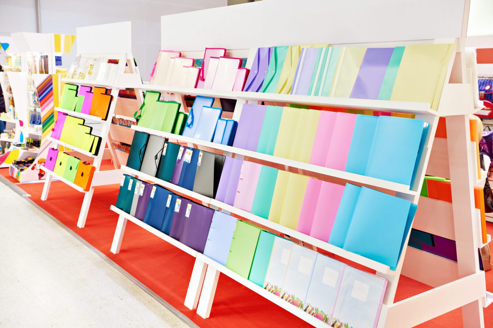 Colorful folders displayed on store shelves.